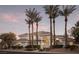 Elegant home featuring palm trees, manicured landscaping, and a circular window detail for curb appeal at 1865 Woodhaven Dr, Henderson, NV 89074