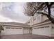 Exterior shot of home showing a three-car garage and tile roof at 1865 Woodhaven Dr, Henderson, NV 89074