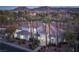 Elegant estate home with lush landscaping, mature palm trees, and a circular driveway at 1865 Woodhaven Dr, Henderson, NV 89074