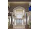 Stately home entrance featuring decorative double doors, pillars, and grand archway at 1865 Woodhaven Dr, Henderson, NV 89074