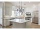 Bright kitchen features white cabinetry, marble countertops, stainless steel appliances, and a kitchen island at 1865 Woodhaven Dr, Henderson, NV 89074