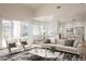 Living room featuring stylish furniture, with views into the dining room, kitchen, and backyard at 1865 Woodhaven Dr, Henderson, NV 89074