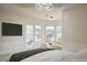 Bright main bedroom with bay window seating area, chandelier, and sliding door access at 1865 Woodhaven Dr, Henderson, NV 89074