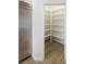 A large walk-in pantry with ample shelving and wood flooring at 1865 Woodhaven Dr, Henderson, NV 89074
