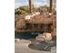 Spectacular rock waterfall feature cascading into a refreshing pool, creating a serene outdoor oasis at 1865 Woodhaven Dr, Henderson, NV 89074