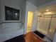 Bathroom featuring tub, glass-enclosed shower, and wood-look floors at 1901 Rolling Dunes Ct, Las Vegas, NV 89117