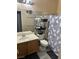 Well-lit bathroom with a single vanity, tiled floors, and a shower curtain at 1901 Rolling Dunes Ct, Las Vegas, NV 89117