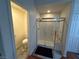 Updated bathroom featuring a modern glass-enclosed shower and tile floors at 1901 Rolling Dunes Ct, Las Vegas, NV 89117