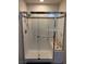 Updated bathroom featuring a modern glass-enclosed shower with bench and grab bars at 1901 Rolling Dunes Ct, Las Vegas, NV 89117