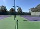 Well-maintained tennis court with net, benches and fencing for recreational enjoyment at 1901 Rolling Dunes Ct, Las Vegas, NV 89117