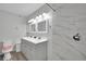 Bathroom featuring dual sinks, modern lighting, and a walk-in shower at 2080 Karen Ave # 1, Las Vegas, NV 89169