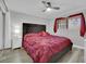 Cozy bedroom with plush red bedding and ample natural light from the window at 2080 Karen Ave # 1, Las Vegas, NV 89169