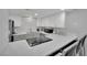Kitchen with white quartz countertops, stainless appliances, and bar seating at 2080 Karen Ave # 1, Las Vegas, NV 89169