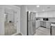Open-concept kitchen with stainless steel refrigerator and clean, white cabinetry at 2080 Karen Ave # 1, Las Vegas, NV 89169