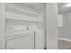 Bright laundry room featuring a new washer, dryer, shelves, and storage space at 2080 Karen Ave # 1, Las Vegas, NV 89169