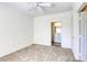 This bedroom has neutral carpet, bright white walls, and a view of the bathroom at 2117 Echo Bay St # 102, Las Vegas, NV 89128