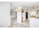 Open-concept dining area with carpeted floors, chandelier lighting, and seamlessly connected to kitchen at 2117 Echo Bay St # 102, Las Vegas, NV 89128