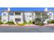 Well-maintained condo building with lush landscaping and a vibrant red rock ground covering at 2117 Echo Bay St # 102, Las Vegas, NV 89128