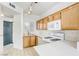 Updated kitchen with oak cabinets, white appliances, tile flooring, and modern countertops at 2117 Echo Bay St # 102, Las Vegas, NV 89128