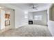 Bright living room featuring a fireplace, ceiling fan, and views of the kitchen area at 2117 Echo Bay St # 102, Las Vegas, NV 89128