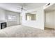 Spacious living room with a fireplace, ceiling fan, plush carpeting, and a large mirrored wall at 2117 Echo Bay St # 102, Las Vegas, NV 89128