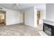 A comfortable living room featuring a fireplace, ceiling fan, and easy access to the bathroom and kitchen at 2117 Echo Bay St # 102, Las Vegas, NV 89128