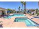 Community pool and jacuzzi surrounded by lounge chairs and palm trees at 2117 Echo Bay St # 102, Las Vegas, NV 89128