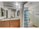 Bathroom featuring double sinks, decorative flower vase, and a bathtub with shower at 2130 Trebbiano Way, Las Vegas, NV 89156