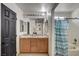 Bathroom featuring double sinks, decorative flower vase, and a bathtub with shower at 2130 Trebbiano Way, Las Vegas, NV 89156