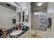 Bathroom featuring sleek countertop, and a shower-tub combo at 2130 Trebbiano Way, Las Vegas, NV 89156