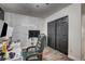 Multi-purpose bedroom featuring a brick accent wall, vinyl flooring, and a closet with black doors at 2130 Trebbiano Way, Las Vegas, NV 89156