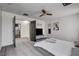 Bedroom featuring modern ceiling fan, art, gray laminate flooring, and neutral decor at 2130 Trebbiano Way, Las Vegas, NV 89156