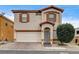 Charming two-story home featuring a stucco exterior, shutters, and a well-maintained front yard in a residential neighborhood at 2130 Trebbiano Way, Las Vegas, NV 89156