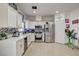 Beautiful kitchen with stainless steel appliances and tile floor flowing into a spacious design at 2130 Trebbiano Way, Las Vegas, NV 89156
