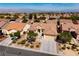 Expansive aerial view of the home showcasing its desert landscaping, tile roof, and proximity to city views at 2219 Sawtooth Mountain Dr, Henderson, NV 89044
