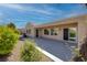 Rear exterior showcasing a covered patio, manicured landscaping, and views of backyard space at 2219 Sawtooth Mountain Dr, Henderson, NV 89044