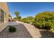Low-maintenance backyard featuring gravel landscaping, mature shrubs, and a covered patio area for relaxing at 2219 Sawtooth Mountain Dr, Henderson, NV 89044