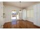 Bright dining area with wood floors, white cabinets, and glass doors to the outdoor space at 2219 Sawtooth Mountain Dr, Henderson, NV 89044