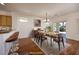 A dining room area is adjacent to the kitchen and features hardwood floors, a dining table and chairs at 2219 Sawtooth Mountain Dr, Henderson, NV 89044