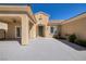 Charming home showcasing a large covered front patio and lush desert landscaping in a well-maintained courtyard at 2219 Sawtooth Mountain Dr, Henderson, NV 89044