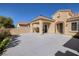 Home's front exterior boasts a covered patio and spacious courtyard featuring beautiful desert landscaping and a fountain at 2219 Sawtooth Mountain Dr, Henderson, NV 89044