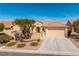 Charming single-story home featuring a two-car garage, desert landscaping, and a well-maintained front yard at 2219 Sawtooth Mountain Dr, Henderson, NV 89044