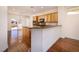 Bright open kitchen featuring wood cabinets, a breakfast bar, and hardwood floors, great for entertaining at 2219 Sawtooth Mountain Dr, Henderson, NV 89044