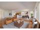 Spacious living room with hardwood floors, a comfortable seating area, and an open floor plan to the dining area at 2219 Sawtooth Mountain Dr, Henderson, NV 89044