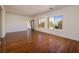 Bright living room with wood floors, large windows and glass door offering views of the community at 2219 Sawtooth Mountain Dr, Henderson, NV 89044