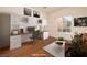 Bright office space featuring custom built-ins, modern desk, and a cozy seating area at 2219 Sawtooth Mountain Dr, Henderson, NV 89044