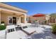 This patio is complete with lounge chairs, an outdoor table and seating under an umbrella, great for entertaining at 2219 Sawtooth Mountain Dr, Henderson, NV 89044