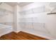 Spacious walk-in closet with ample storage space provided by wire shelving on wood floor at 2219 Sawtooth Mountain Dr, Henderson, NV 89044
