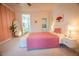 Comfortable bedroom featuring a pink accent wall, and large mirror and plant at 2251 Van Gogh Dr, Henderson, NV 89074