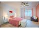 Bright bedroom featuring a ceiling fan, large window and a cozy sitting area at 2251 Van Gogh Dr, Henderson, NV 89074